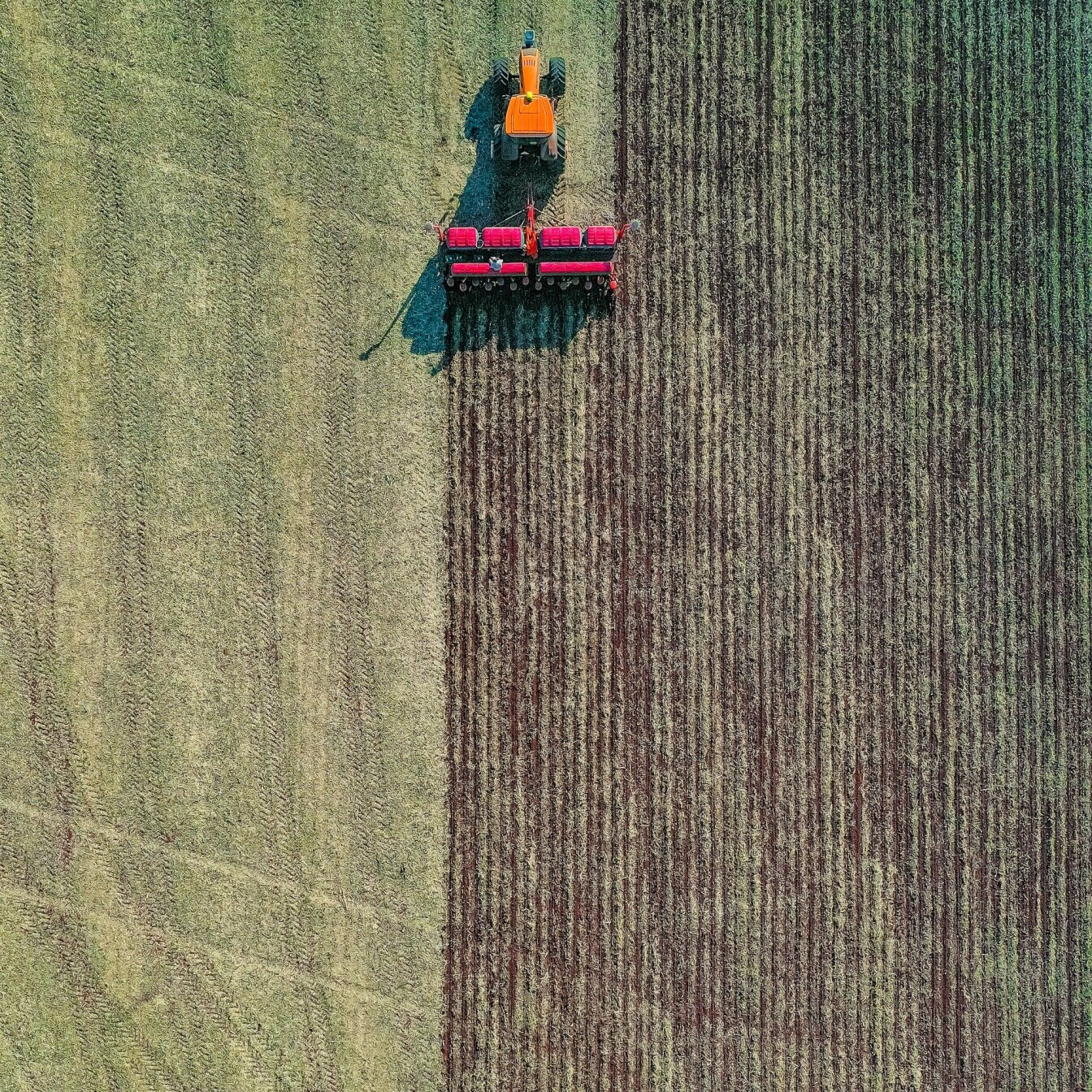 Aerial shot of a tractor pulling a plough
